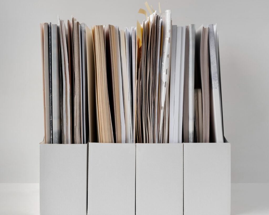 neatly arranged documents on marble shelf minimal.